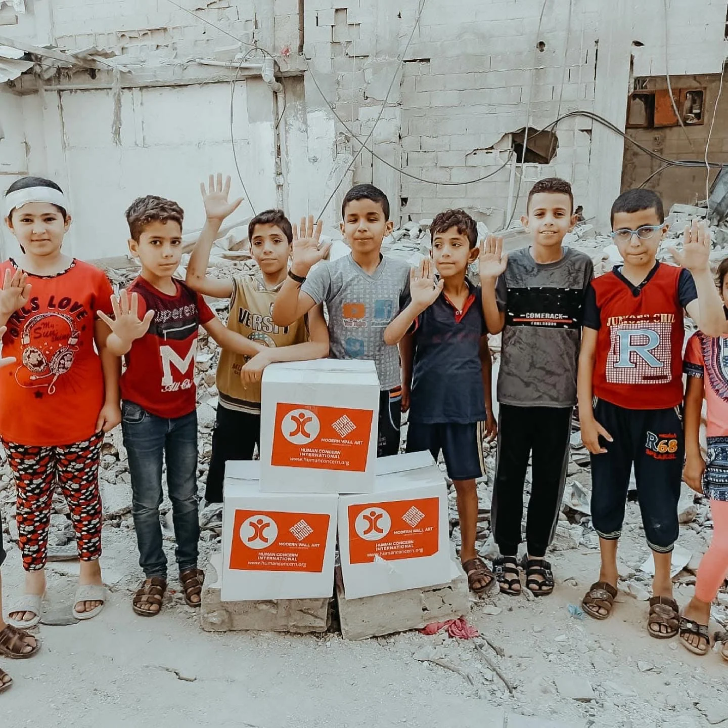 Children holding relief boxes delivered by MWA Charity